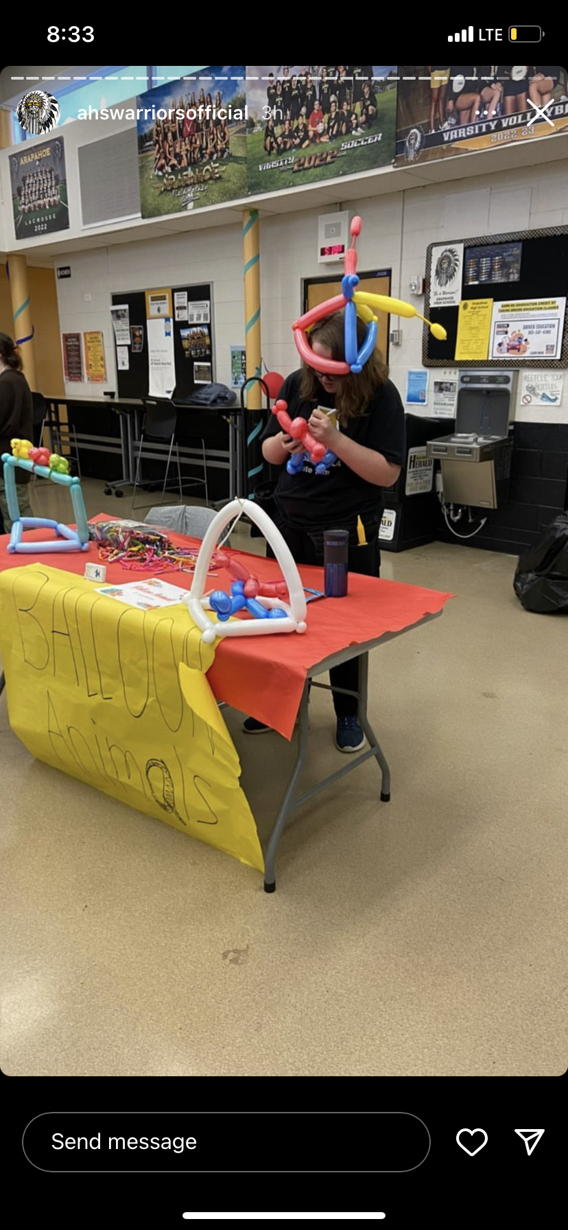 Rachel making balloon animals for kids at a carnival
