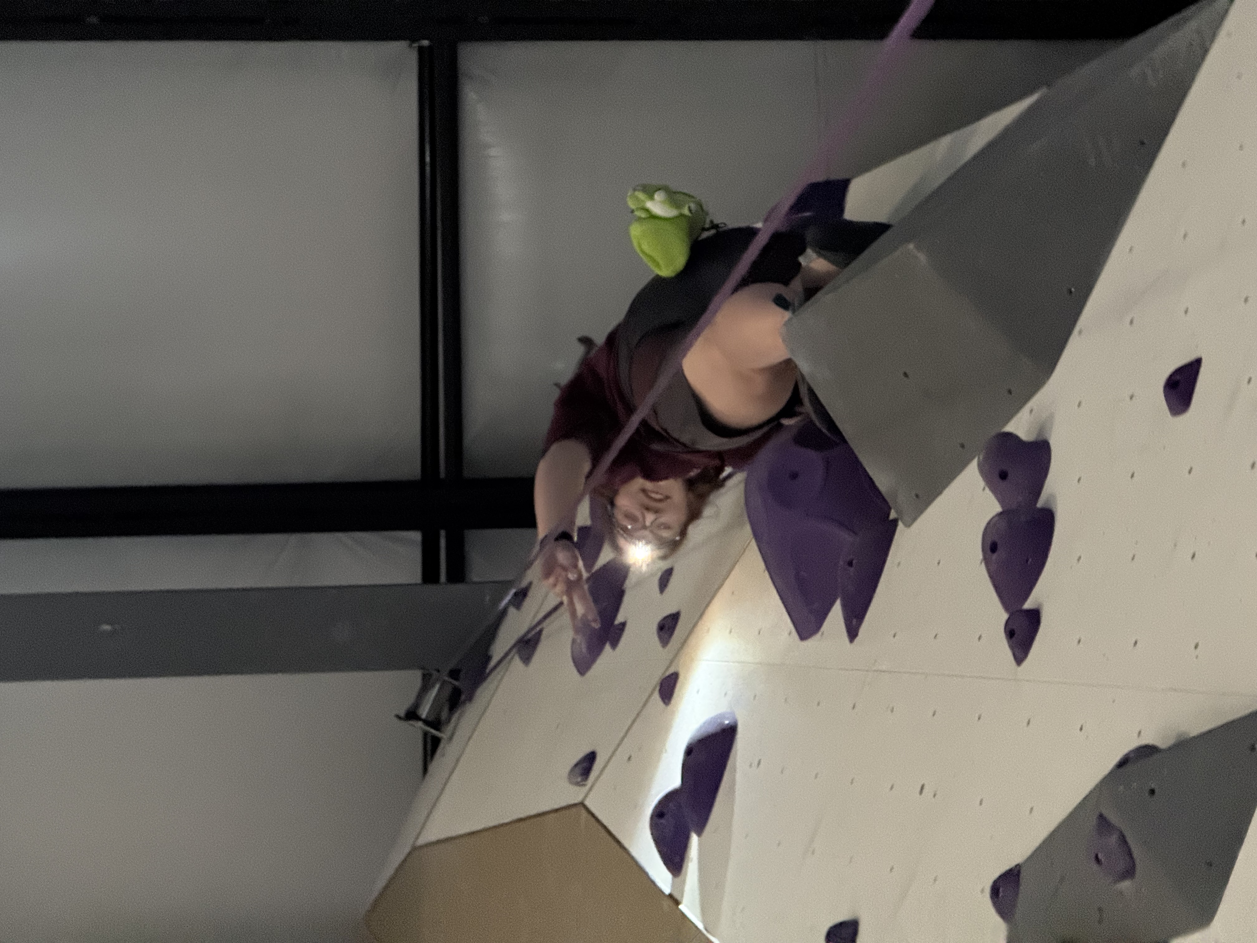 Rachel climbing on a blackout night at the local climbing gym